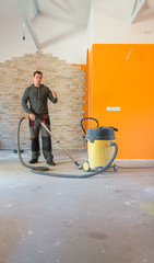 Worker Vacuuming a Construction Site
