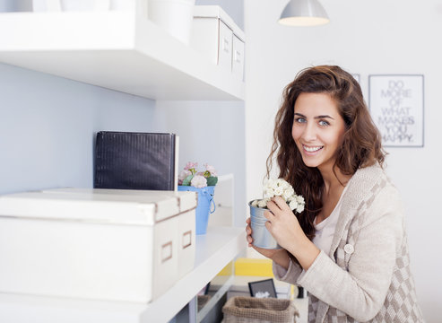 Beautiful Woman Arranging Flowers And Decorating Her Living Room Shallow Depth Of Field.