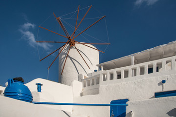 Windmill next to a Greek Orthodox church in Oia town on the island of Santorini, Greece