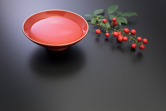 vermilion lacquer coated sake cup and red nuts. vermilion sake cups are used for festive meals, especially for New Year celebration or wedding ceremonies.