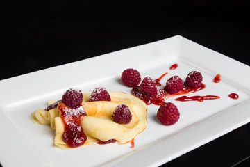 Pancake with raspberry sauce.