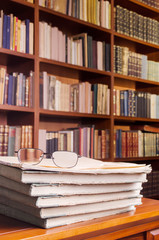 Glasses on books at library table