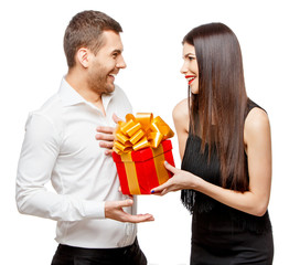 Young beautiful couple with present isolated on white