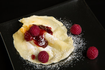 Pancake with raspberry sauce.