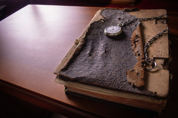 Female student with elbows on the table looking at books 