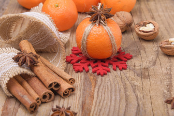 Fototapeta premium Still life with tangerines on a wooden background.