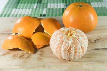 Orange and peel on wooden block