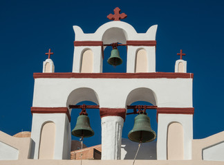 Bell tower at a Greek Orthodox church in Oia town on the island of Santorini, Greece
