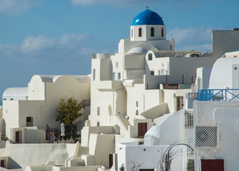 A blue-domed Greek Orthodox church in Oia town on the island of Santorini, Greece
