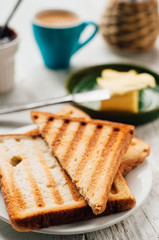 Breakfast with coffee, toasts, butter and jam