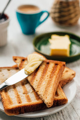 Breakfast with coffee, toasts, butter and jam