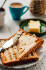 Breakfast with coffee, toasts, butter and jam