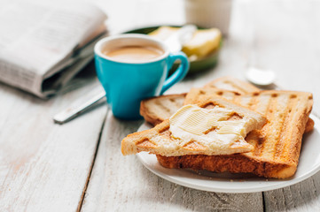 Breakfast with coffee, toasts, butter and jam