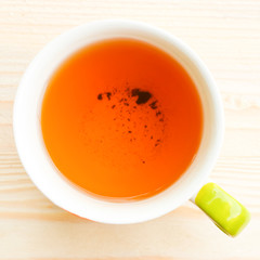 Cup of tea on bright wooden background