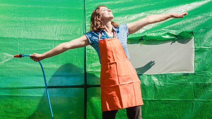 Woman watering the garden with hose