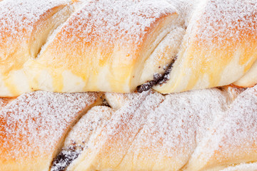 Homemade pastries with poppy seeds on a wooden background