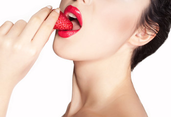 Sexy mouth of a woman eating strawberry