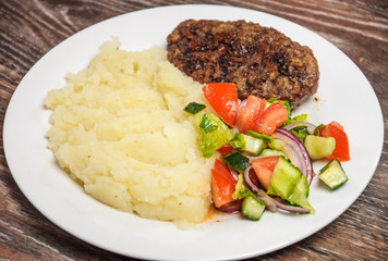Fried cutlet, mashed potatoes and fresh vegetable salad
