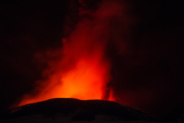 Fototapeta na wymiar Volcano eruption. Mount Etna erupting from the crater Voragine 
