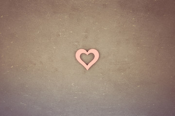 Heart shape symbol over vintage chalkboard, retro filter applied