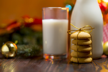 Cookie and milk on wooden table for Santa Claus.