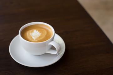 Hot art Latte Coffee in a cup on wooden table.