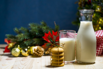 Cookie and milk on wooden table for Santa Claus.