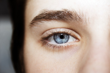 Naklejka premium An insightful beautiful look boy's blue eye