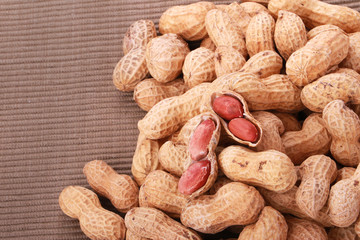 Monkey nuts, peanuts or groundnuts in shells, isolated on a white background