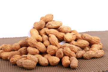 Monkey nuts, peanuts or groundnuts in shells, isolated on a white background