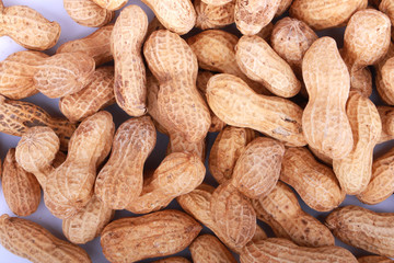Monkey nuts, peanuts or groundnuts in shells, isolated on a white background