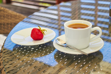 morning coffee with strawberries on a table on the terrace, dess
