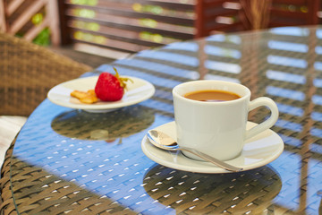 morning coffee with strawberries on a table on the terrace, dess