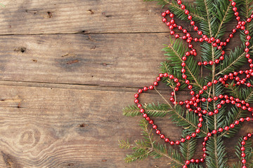Christmas background - Christmas ornaments on fir tree - on wooden background