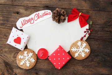 Christmas background with paper, gift box, cookies, pine cone and ribbon - copy space for text