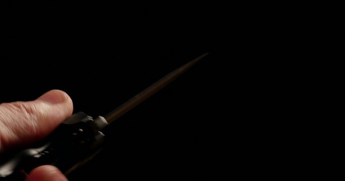 4K - Folding knife in hand. macro
