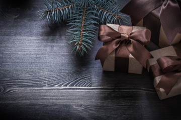 Pine branch Christmas presents on wooden board holiday concept