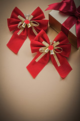 Wrapped box-container with tied ribbon red bows holidays concept