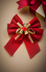 Wrapped gift box bow on golden background holidays concept