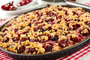 Tasty homemade pie with cherries on table close up