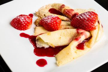 Pancake with strawberry sauce.
