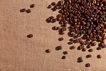 Roasted coffee beans on the linen fabric