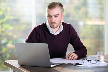 Businessman working with laptop in office