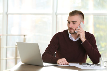 Businessman working with laptop in office