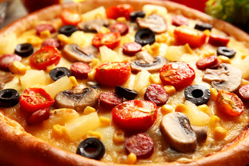 Delicious pizza with vegetables and meat, close-up