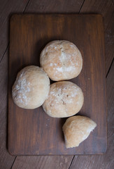 Small buns on a dark wooden background. Selective focus