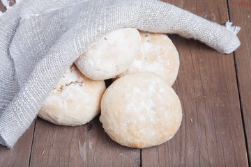 Small buns on a dark wooden background. Selective focus