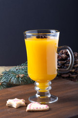 Glass of sea buckthorn beverage (kissel) and colored gingerbread