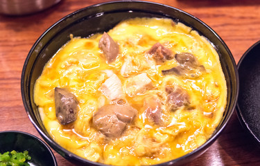 Bowl of rice topped with chicken and eggs at Tamahide,tokyo,japan