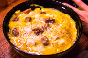 Bowl of rice topped with chicken and eggs at Tamahide,tokyo,japan